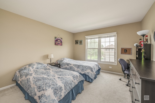 1805 Marne Road Bolingbrook, IL 60490 - Photo 22 of 27 a bedroom with two beds and a desk