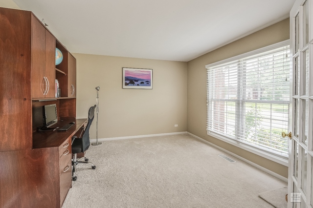 1805 Marne Road Bolingbrook, IL 60490 - Photo 4 of 27 a view of a livingroom with workspace and a window