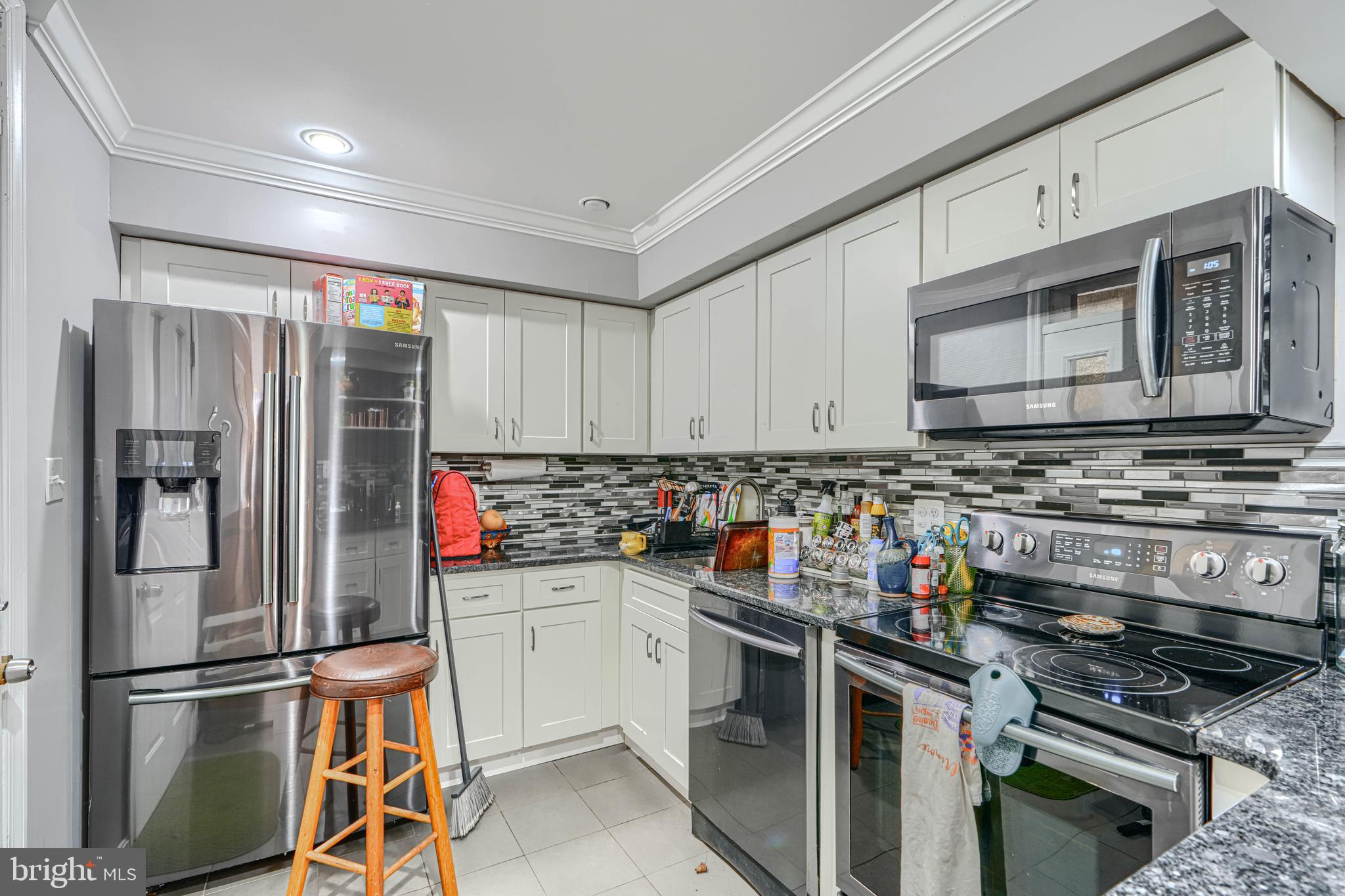 108 North Madeira Street Baltimore, MD 21231 - Photo 4 of 17 a kitchen with stainless steel appliances a stove a sink and a refrigerator