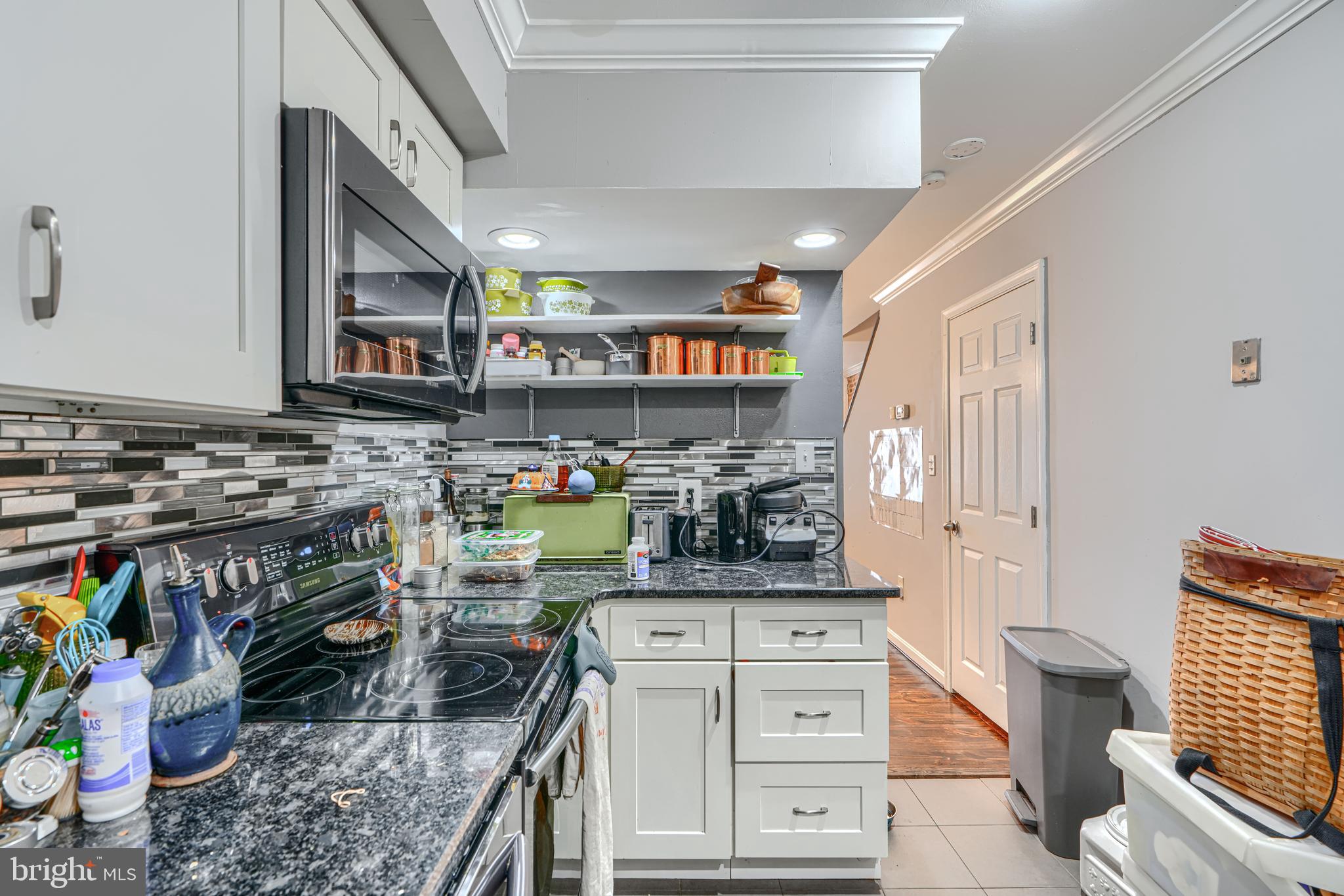 108 North Madeira Street Baltimore, MD 21231 - Photo 5 of 17 a kitchen with stainless steel appliances granite countertop a stove and cabinets