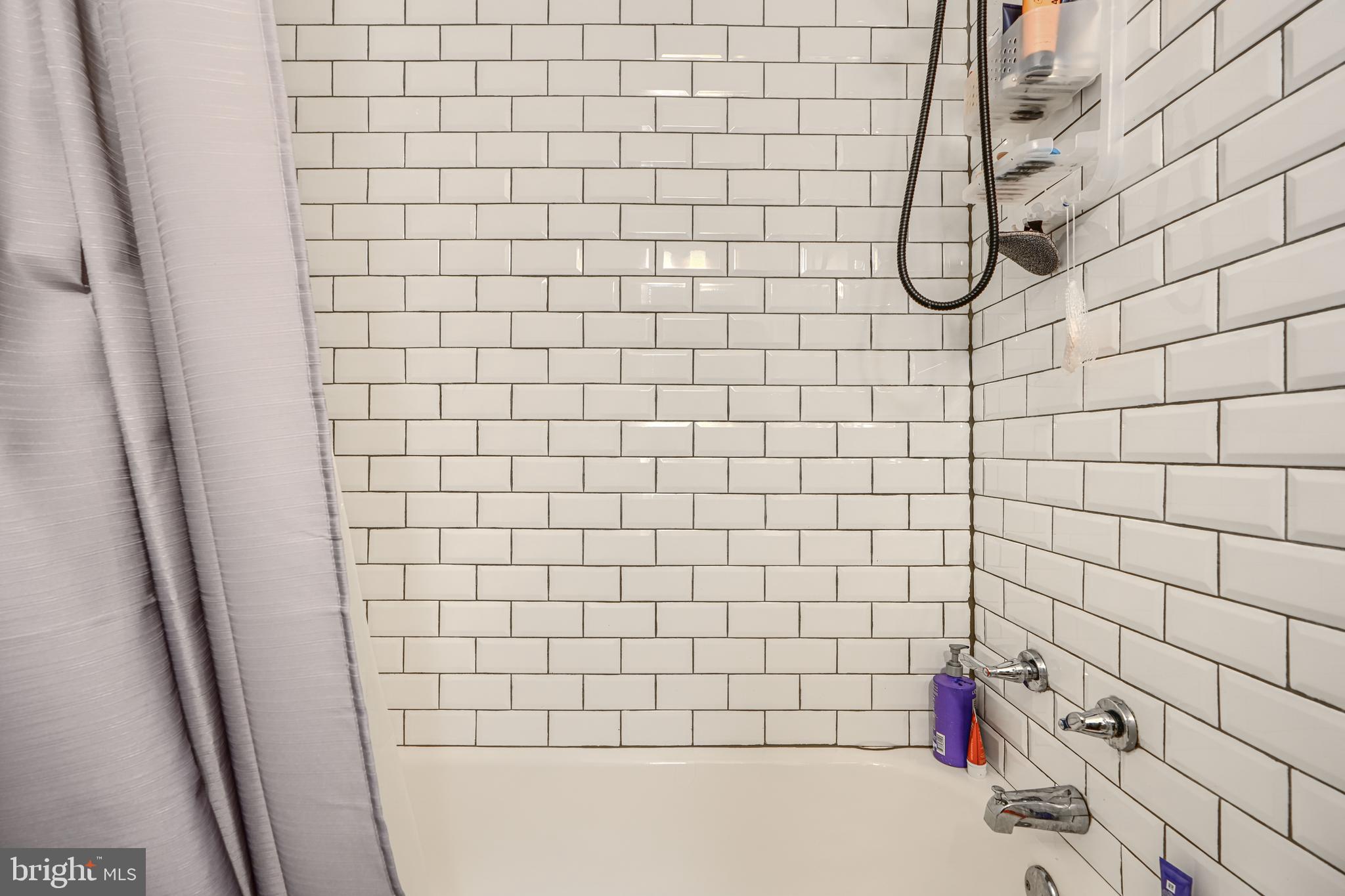 108 North Madeira Street Baltimore, MD 21231 - Photo 10 of 17 a bathroom with a white bathtub and shower