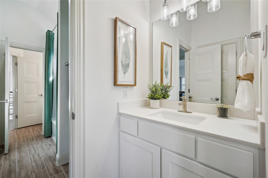 1604 Casting Ridge Mesquite, TX 75181 - Photo 31 of 38 Bathroom vanity with a white countertop and undermount sink, complemented by a contemporary light fixture