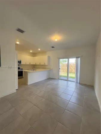 a view of a kitchen with a sink and a window
