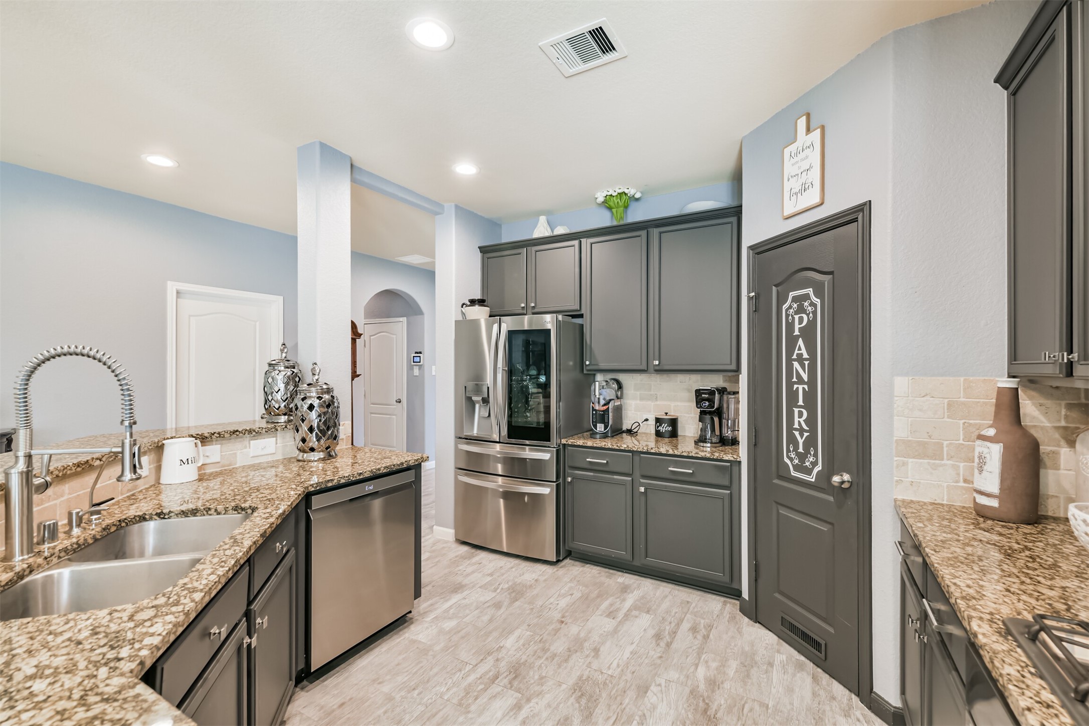 24047 Schults Meadow Lane Spring, TX 77389 - Photo 14 of 47 a kitchen with stainless steel appliances granite countertop a refrigerator a stove a sink and a microwave