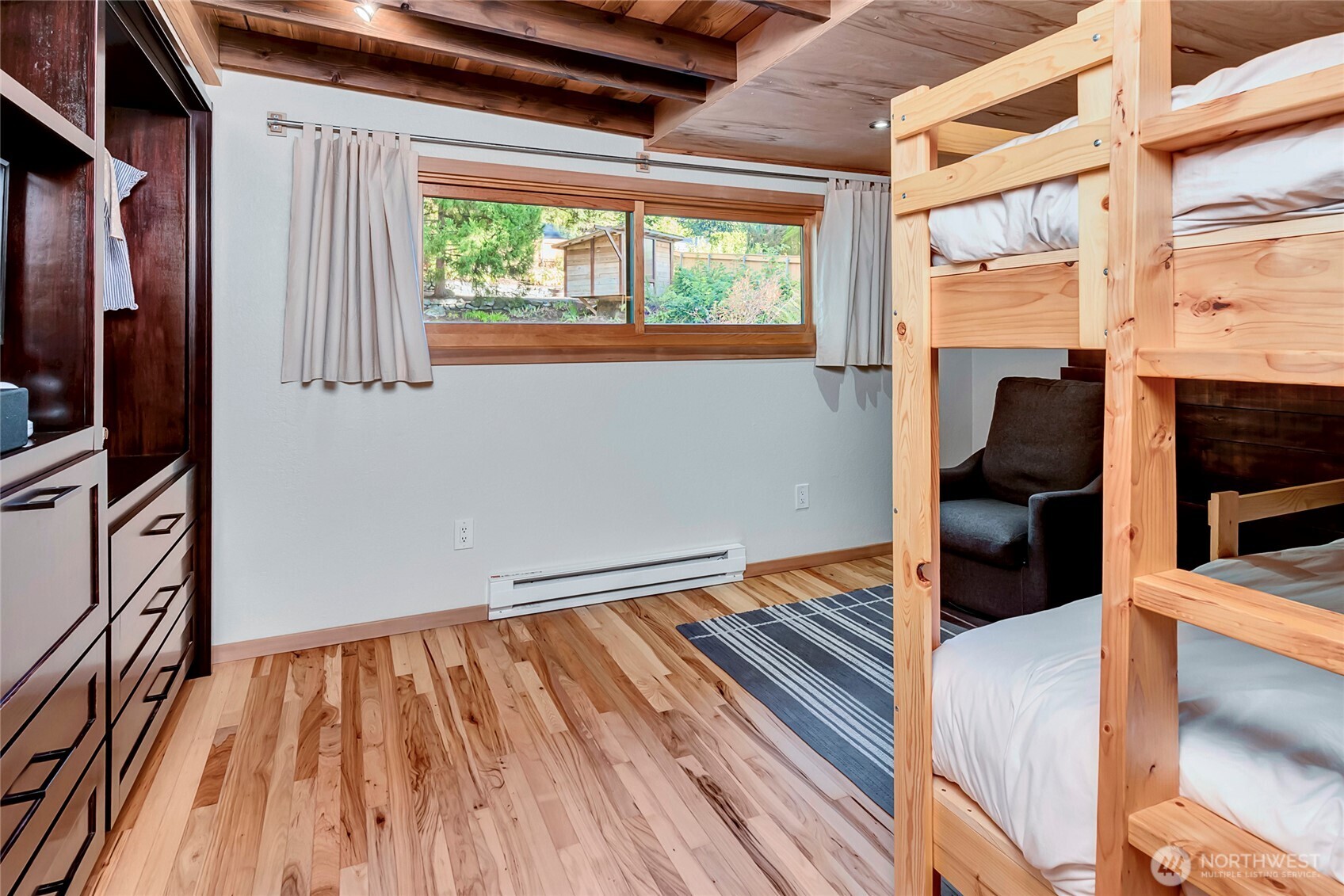 24123 7th Avenue West Bothell, WA 98021 - Photo 19 of 29 a view of an empty room with wooden floor and a window