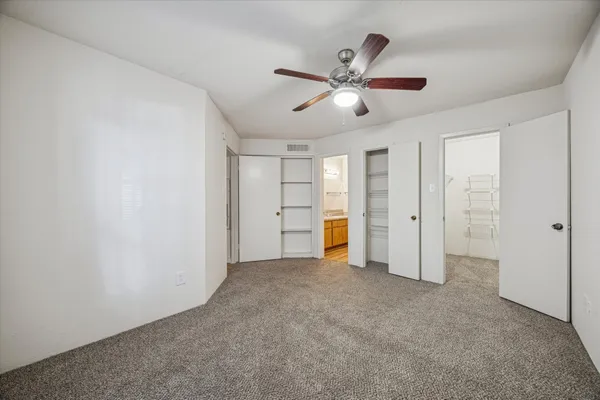 a view of an empty room and closet area