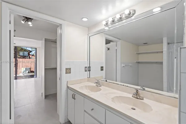 a bathroom with a sink double vanity and shower