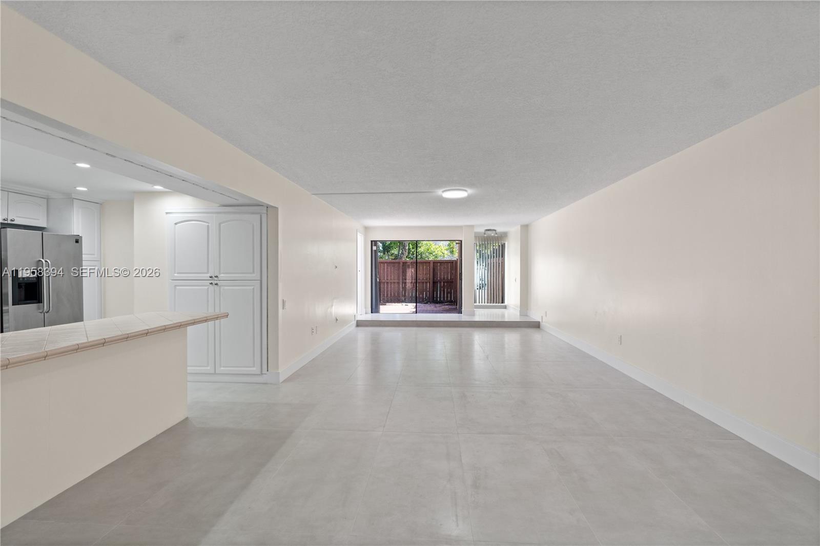 6907 Southwest 115th Place, Unit D40 Miami, FL 33173 - Photo 13 of 38 a view of an empty room with a window