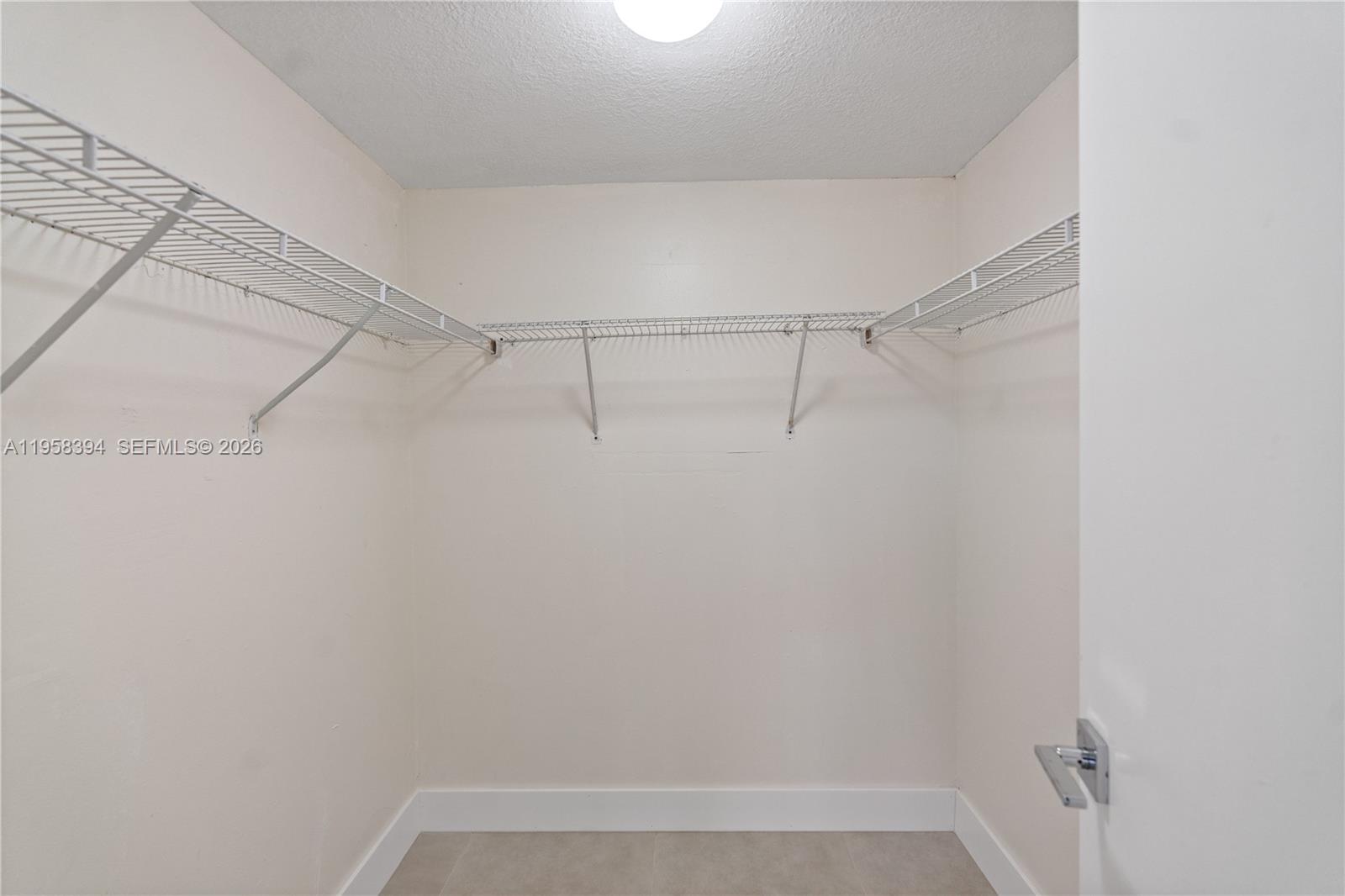 6907 Southwest 115th Place, Unit D40 Miami, FL 33173 - Photo 28 of 38 a view of a room with racks on the wall