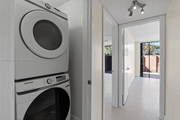 a view of a hallway with washer and dryer