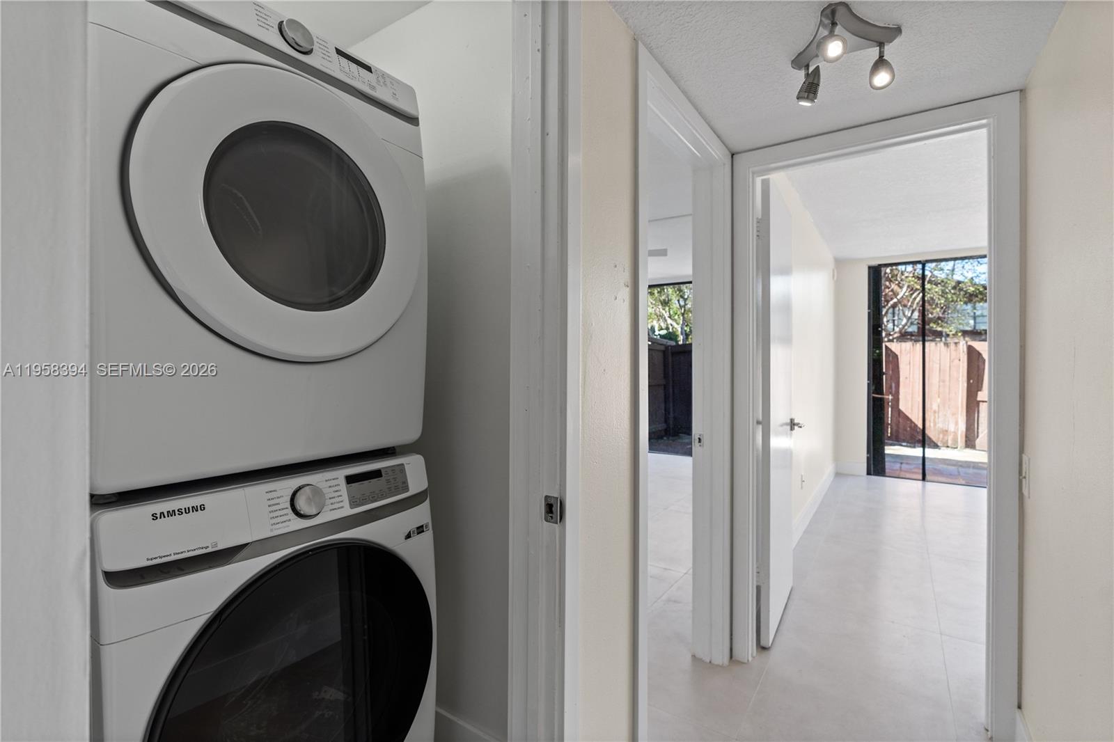 6907 Southwest 115th Place, Unit D40 Miami, FL 33173 - Photo 29 of 38 a view of a hallway with washer and dryer