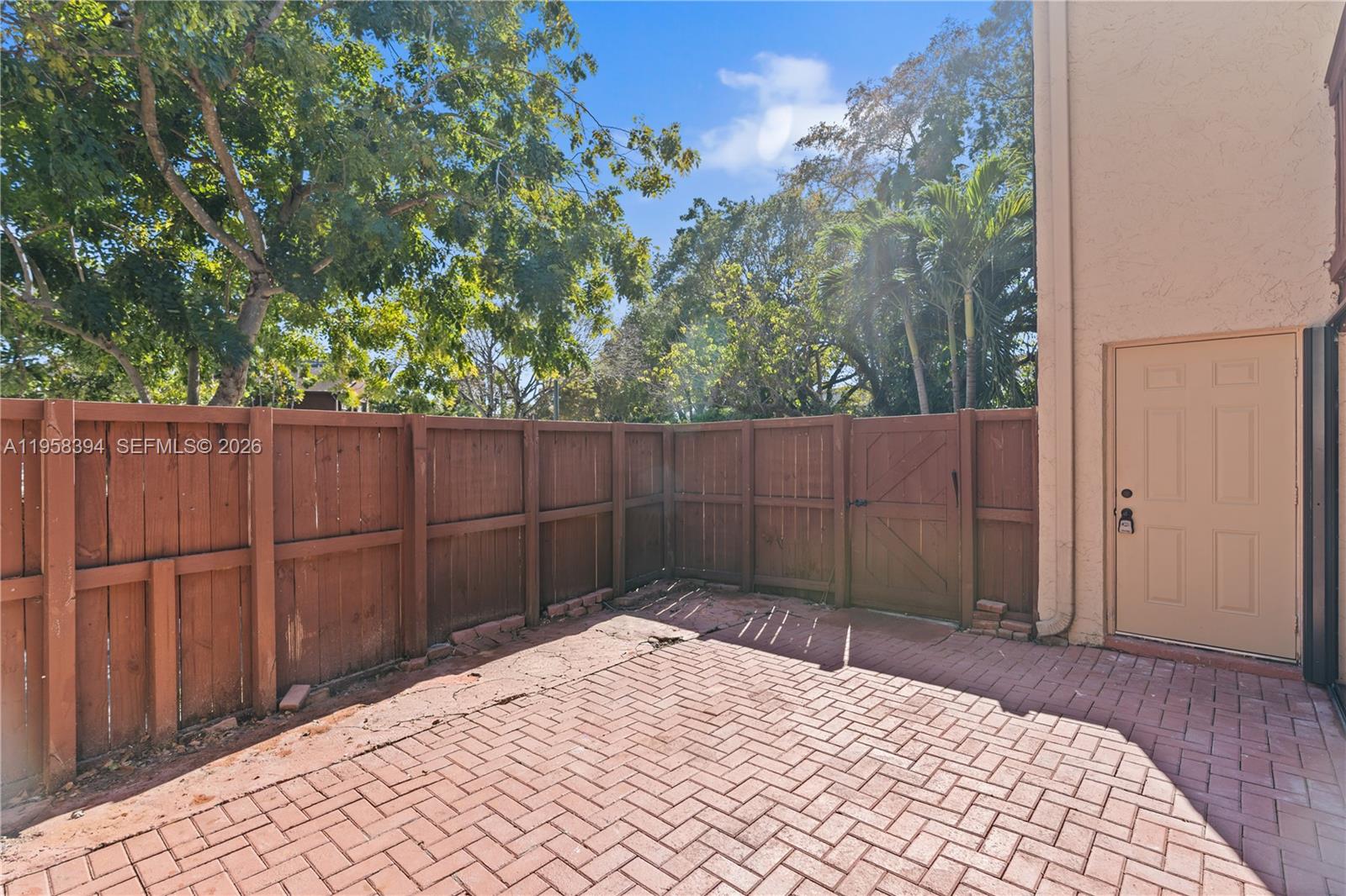 6907 Southwest 115th Place, Unit D40 Miami, FL 33173 - Photo 3 of 38 a view of backyard with wooden fence