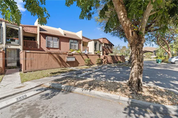 an aerial view of residential houses with outdoor space and city view