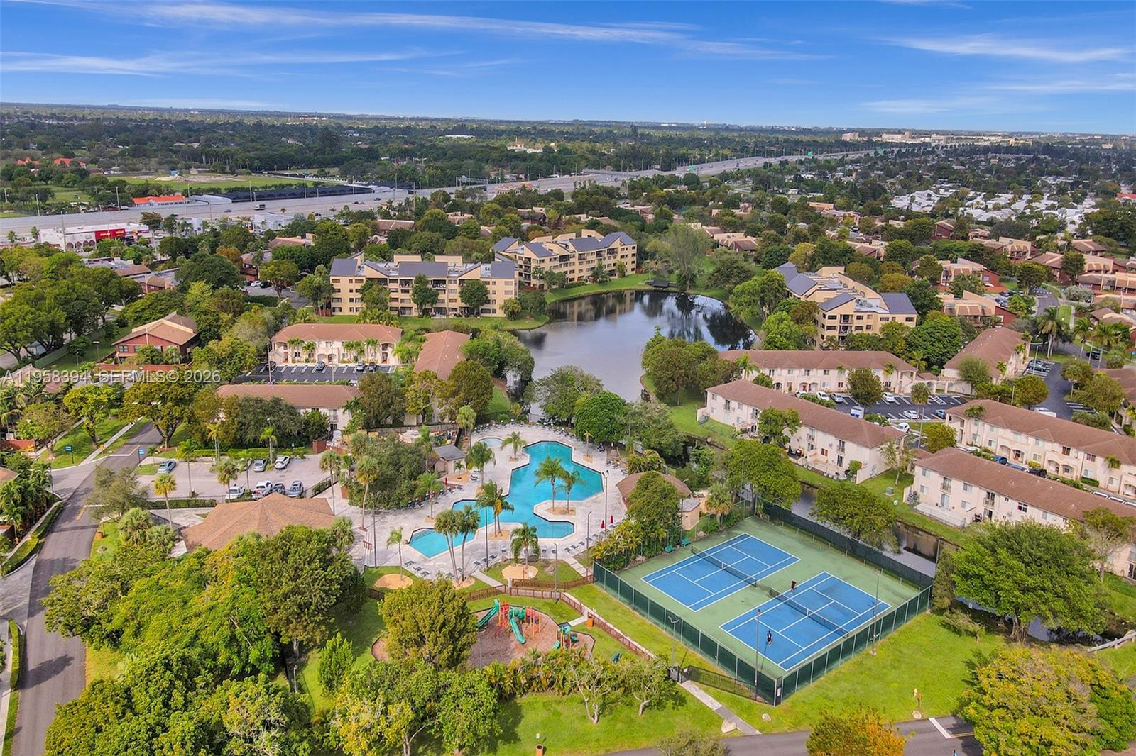 6907 Southwest 115th Place, Unit D40 Miami, FL 33173 - Photo 36 of 38 an aerial view of residential houses with outdoor space