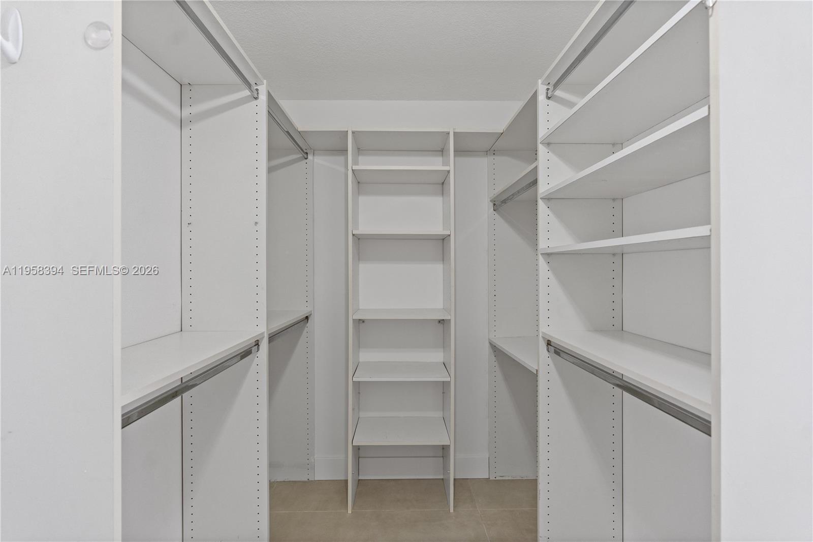 6907 Southwest 115th Place, Unit D40 Miami, FL 33173 - Photo 7 of 38 a view of walk in closet with empty racks