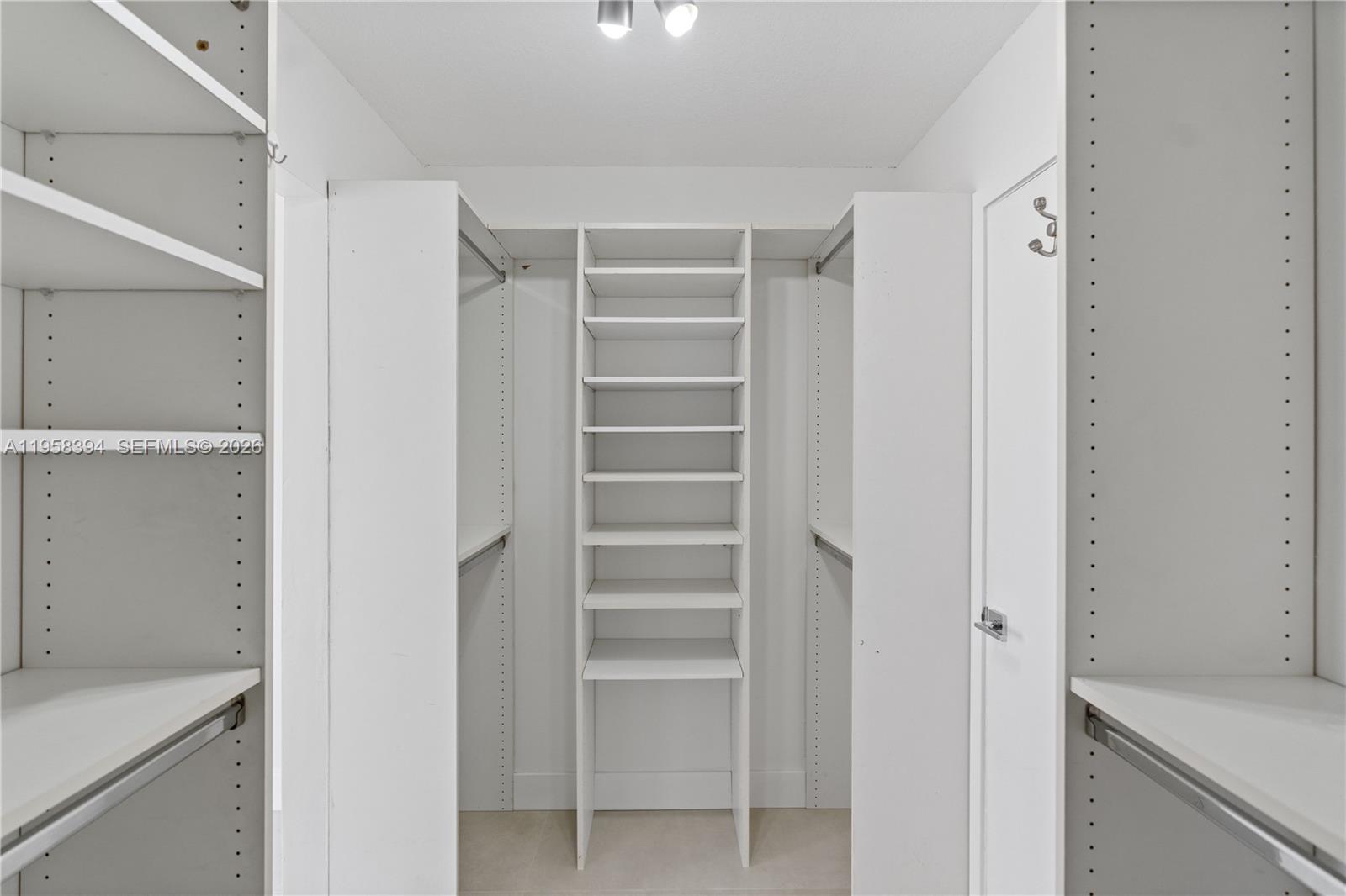6907 Southwest 115th Place, Unit D40 Miami, FL 33173 - Photo 8 of 38 a view of walk in closet with empty racks