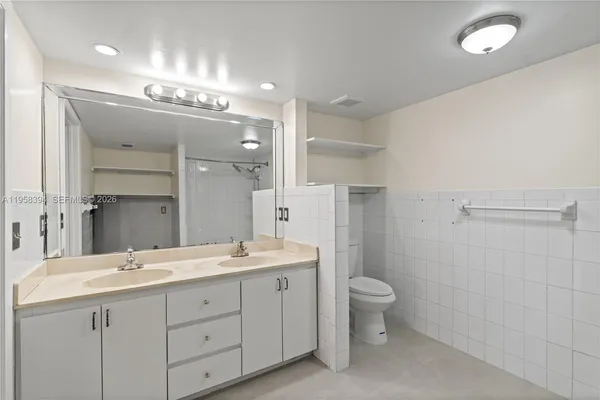a spacious bathroom with a double vanity sink mirror and toilet