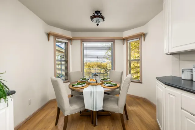 a view of a dining room with furniture and windows