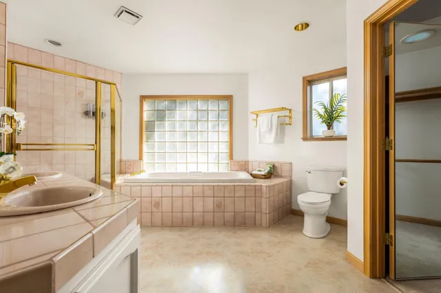 a bathroom with a granite countertop toilet a sink and a bathtub