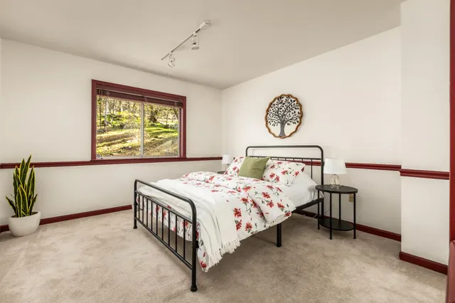 a bedroom with a bed and a window