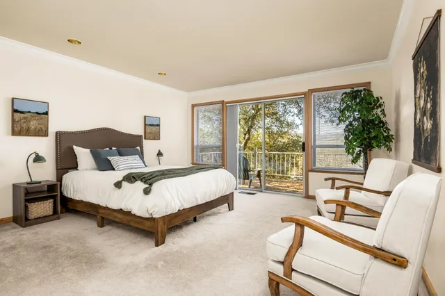 a spacious bedroom with a bed and a large window