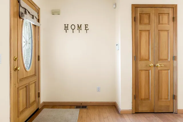 a view of front door with wooden floor