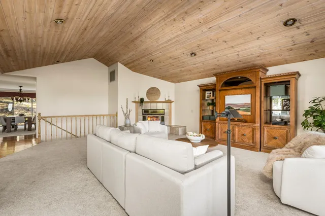 a view of living room with furniture and large window