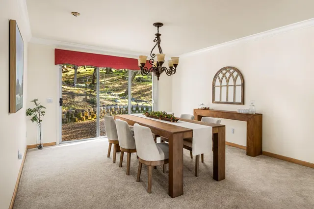 a view of a dining room with furniture window and outside view