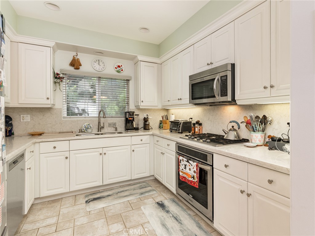 328 Virginia Street, Unit 4 El Segundo, CA 90245 - Photo 11 of 26 a kitchen with granite countertop white cabinets and white appliances