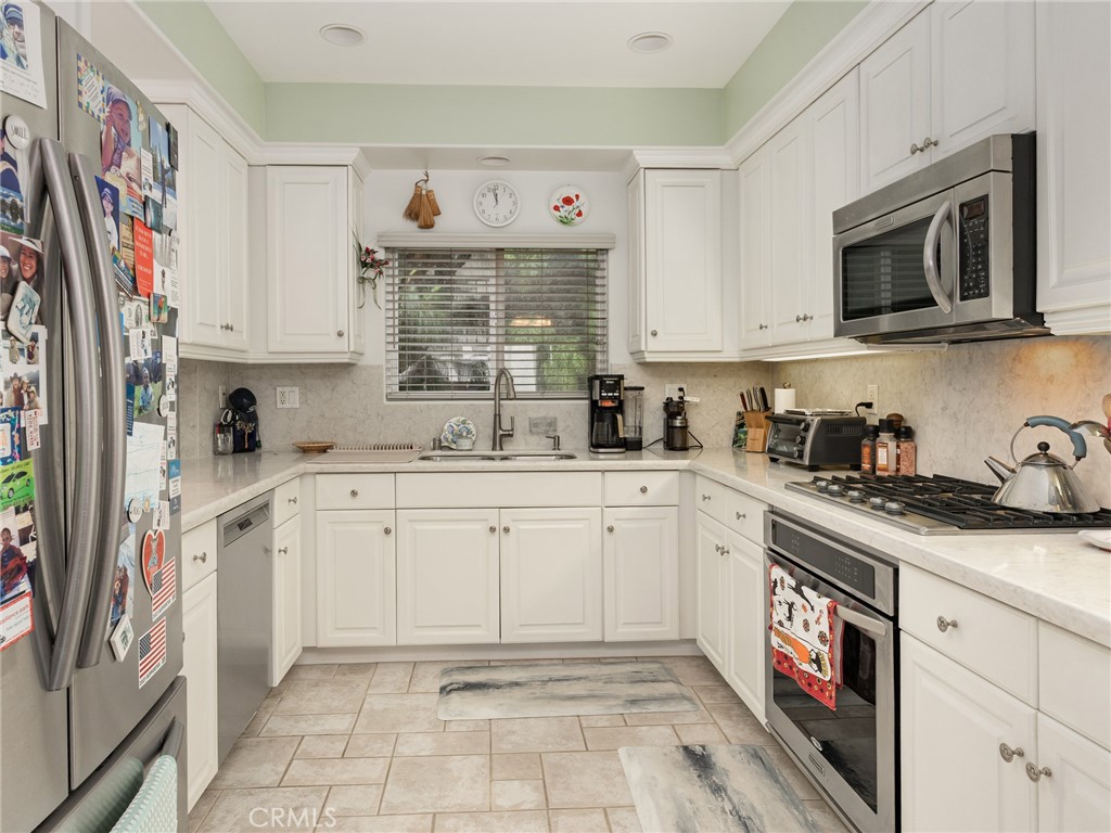 328 Virginia Street, Unit 4 El Segundo, CA 90245 - Photo 10 of 26 a kitchen with stainless steel appliances granite countertop a sink and dishwasher a microwave oven with cabinets