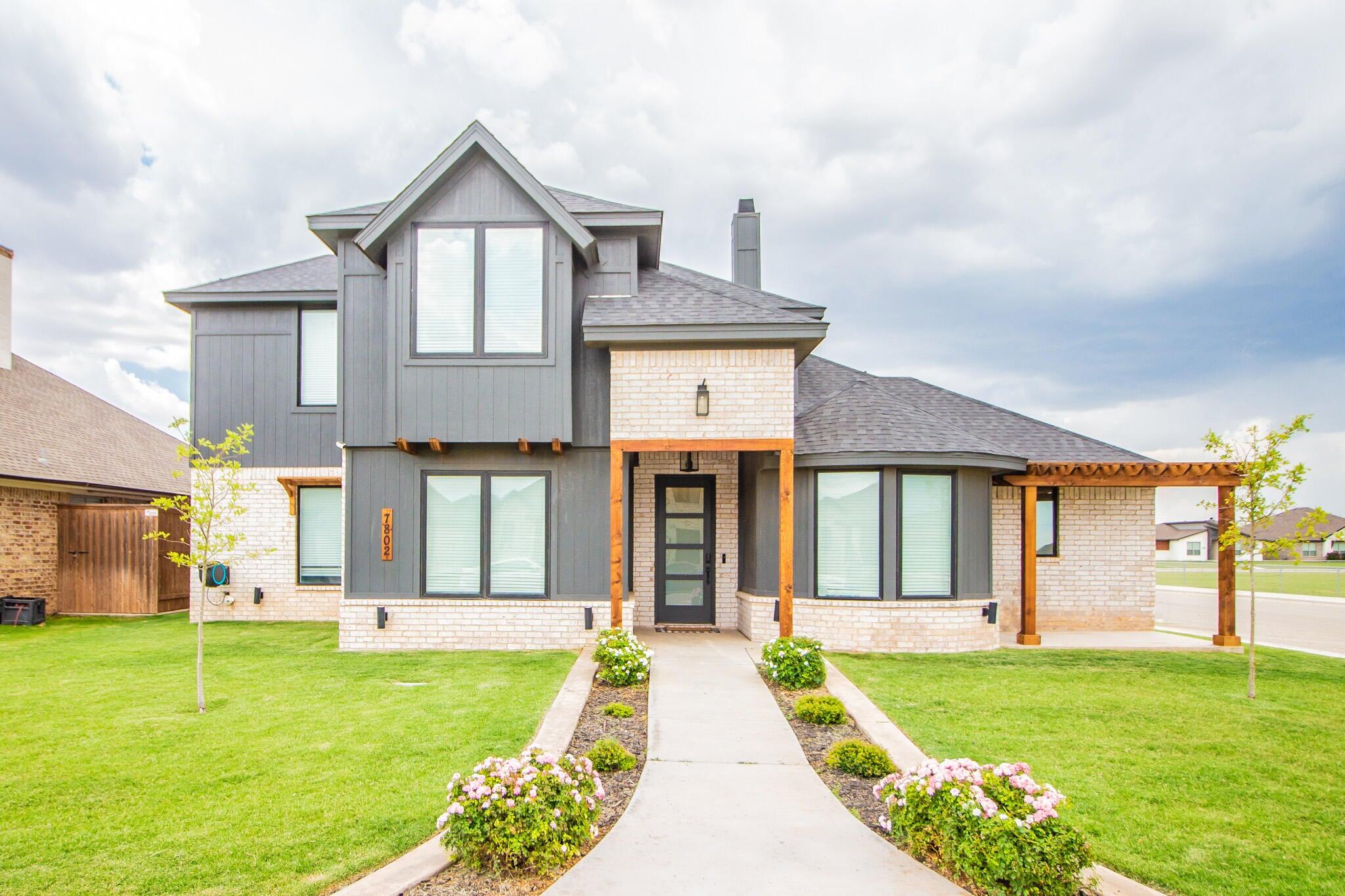 a front view of a house with garden