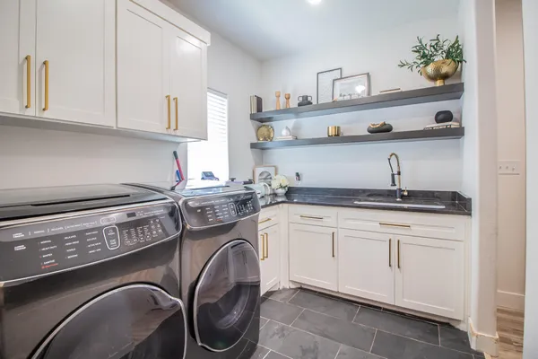 a kitchen with stainless steel appliances granite countertop a sink and wooden cabinets