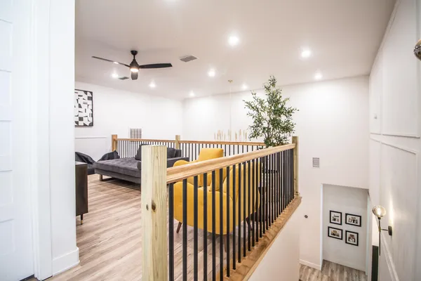 a living room with furniture and a wooden floor
