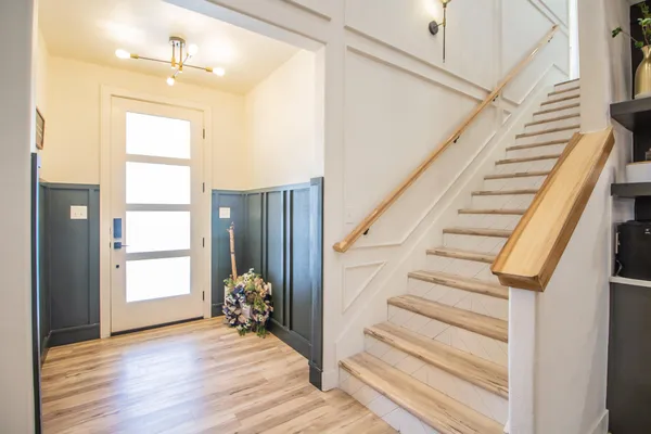 a view of entryway with wooden floor and stairs