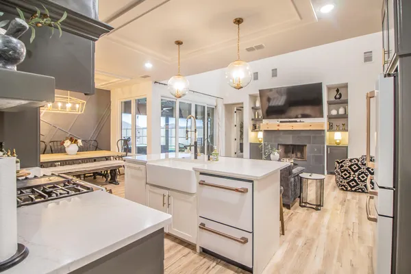a kitchen with a stove oven and a view of living room