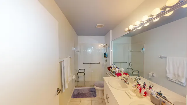 a bathroom with a sink vanity mirror and tub