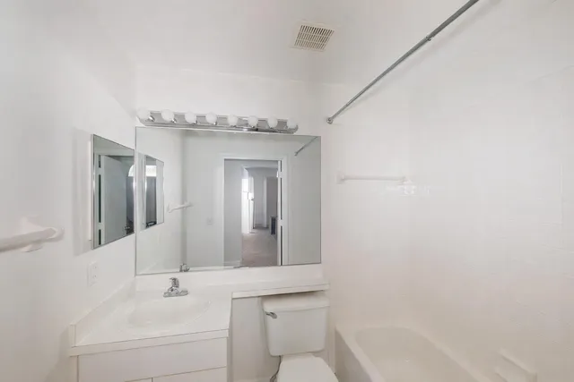 a sign board with buildings in the background