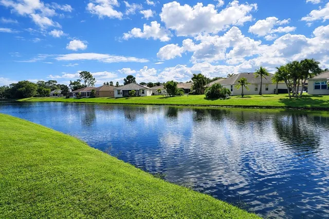 a view of a lake with houses in the back