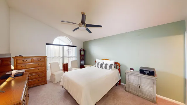 a bedroom with a bed and dresser