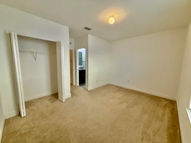 an empty room with closet area