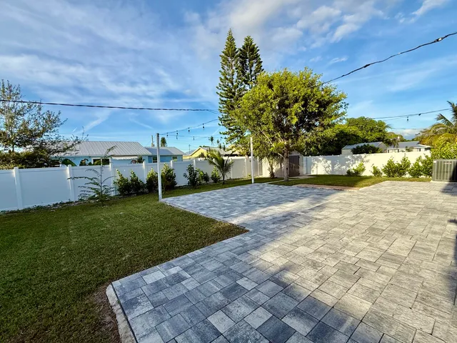 a view of a backyard with plants and a garden