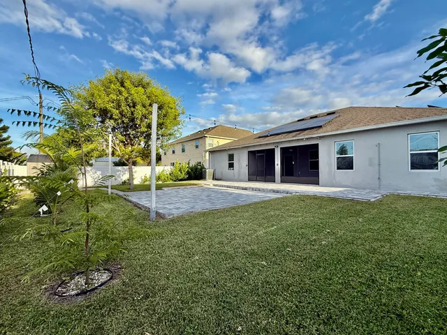 a view of a house with backyard porch and garden