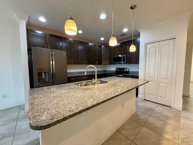 a bathroom with a granite countertop sink and a large mirror