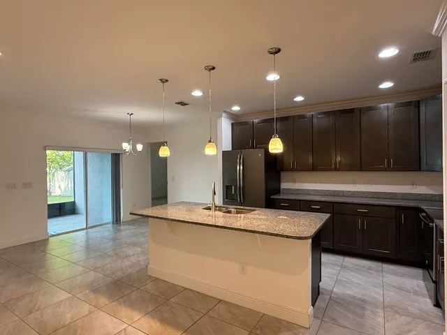 a kitchen with a sink cabinets and window