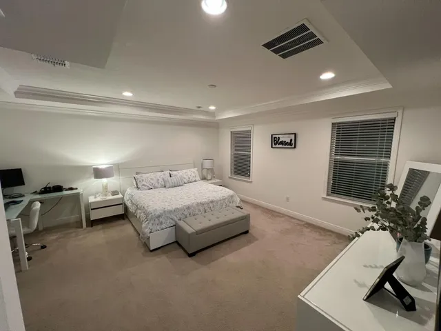 a spacious bedroom with a bed and furniture