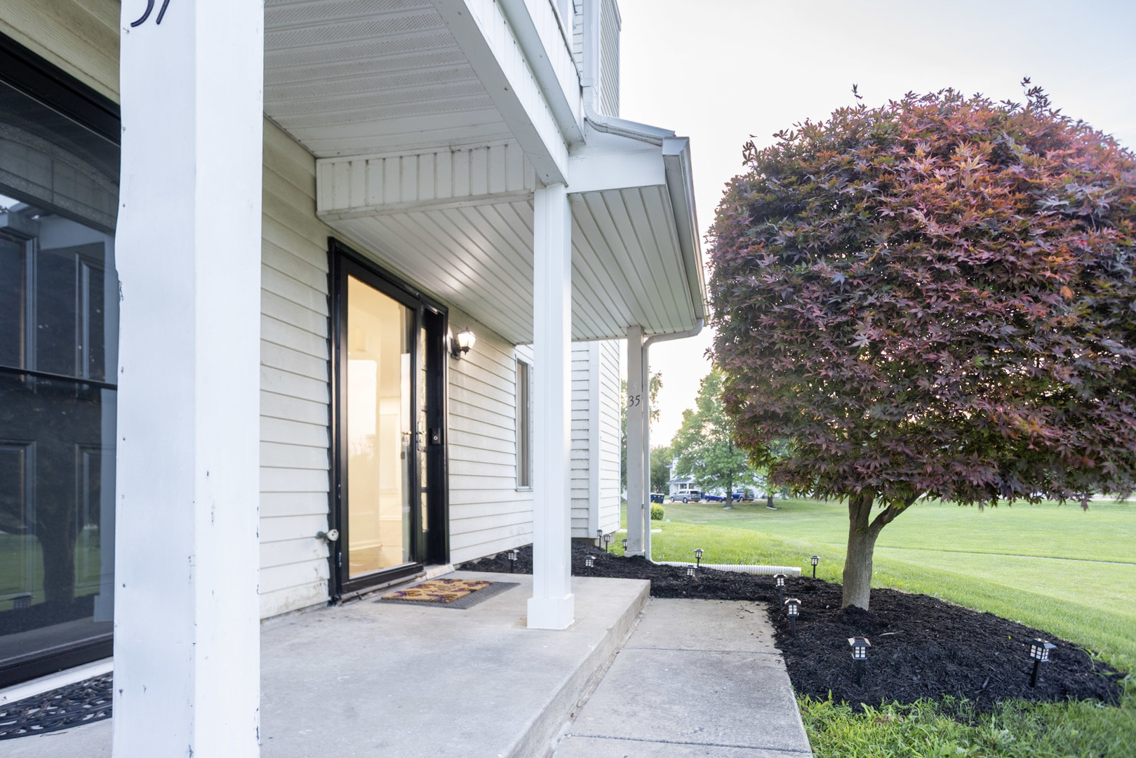 a view of a pathway with a house in the background