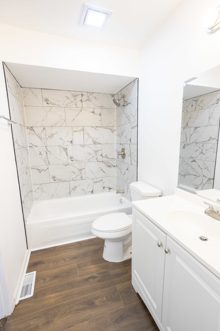 35 Churn Road, Unit 35 Matteson, IL 60443 - Photo 12 of 18 a bathroom with a sink a toilet and shower