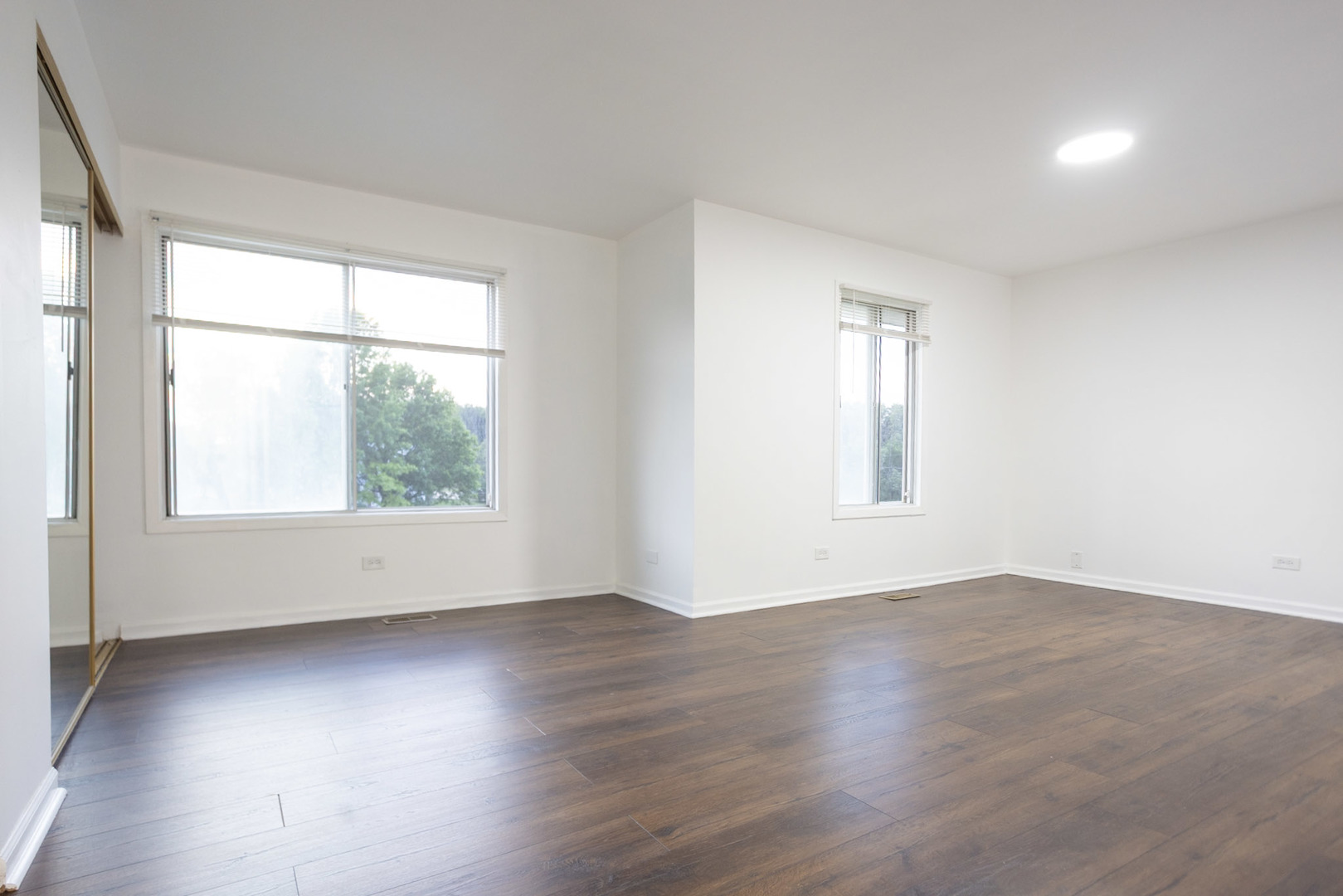 35 Churn Road, Unit 35 Matteson, IL 60443 - Photo 14 of 18 an empty room with wooden floor and windows