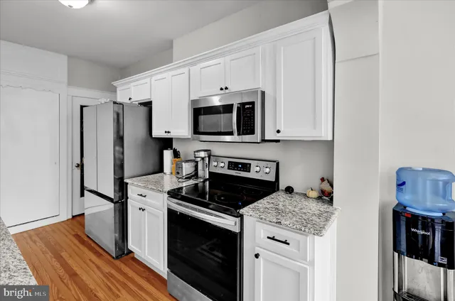 a kitchen with stainless steel appliances a stove microwave and refrigerator