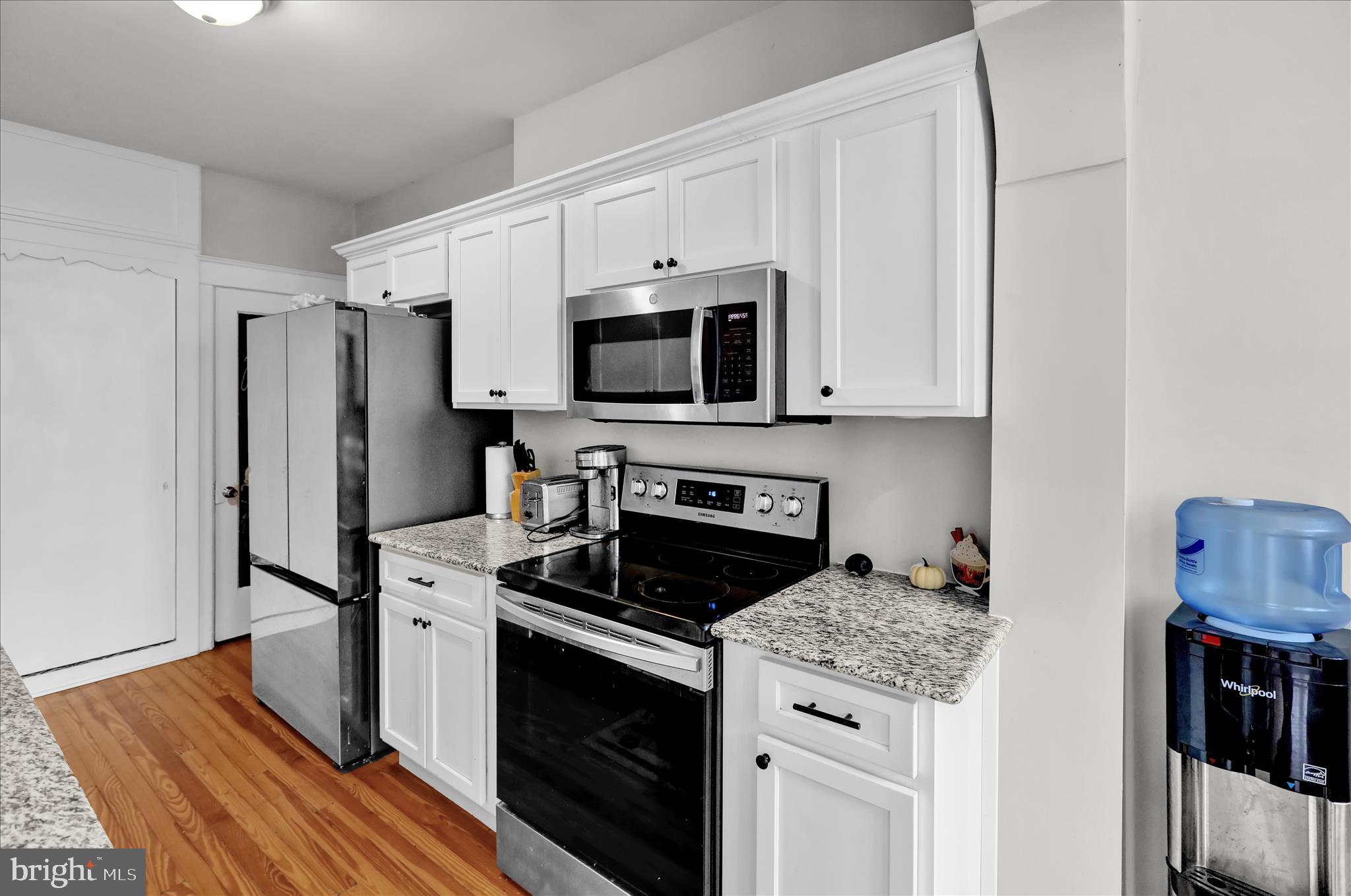 1722 Olive Street Reading, PA 19604 - Photo 13 of 31 a kitchen with stainless steel appliances a stove microwave and refrigerator